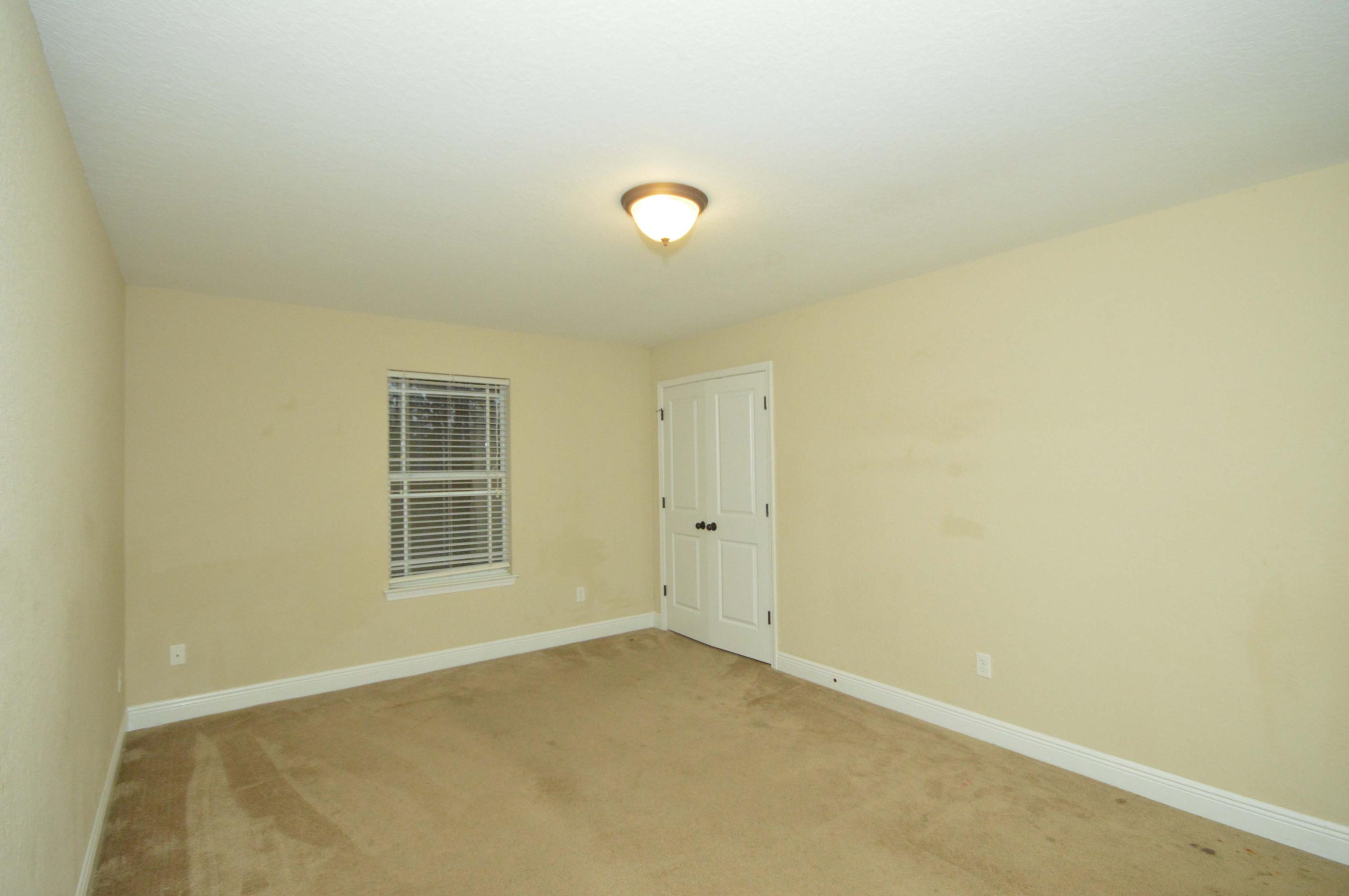 9970 Nichols Lake Road Milton, FL 32583 - Photo 26 of 48 an empty room with windows