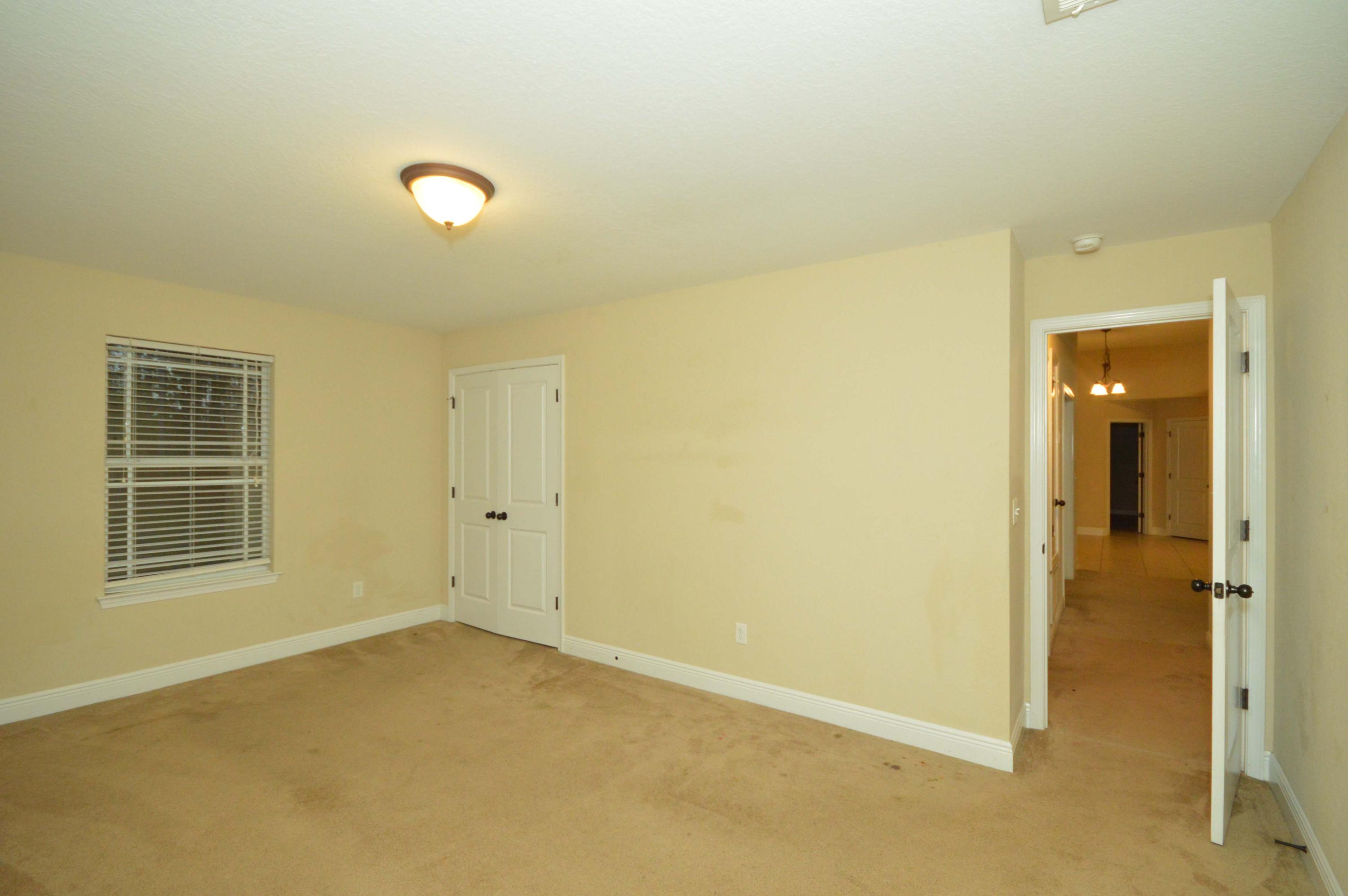 9970 Nichols Lake Road Milton, FL 32583 - Photo 27 of 48 an empty room with a empty space and windows