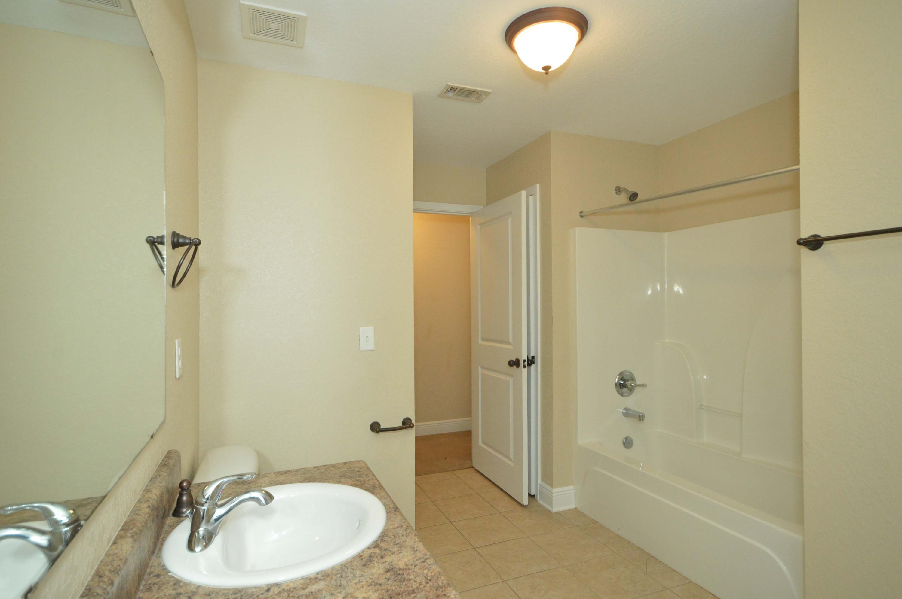 9970 Nichols Lake Road Milton, FL 32583 - Photo 32 of 48 a bathroom with a sink and a mirror