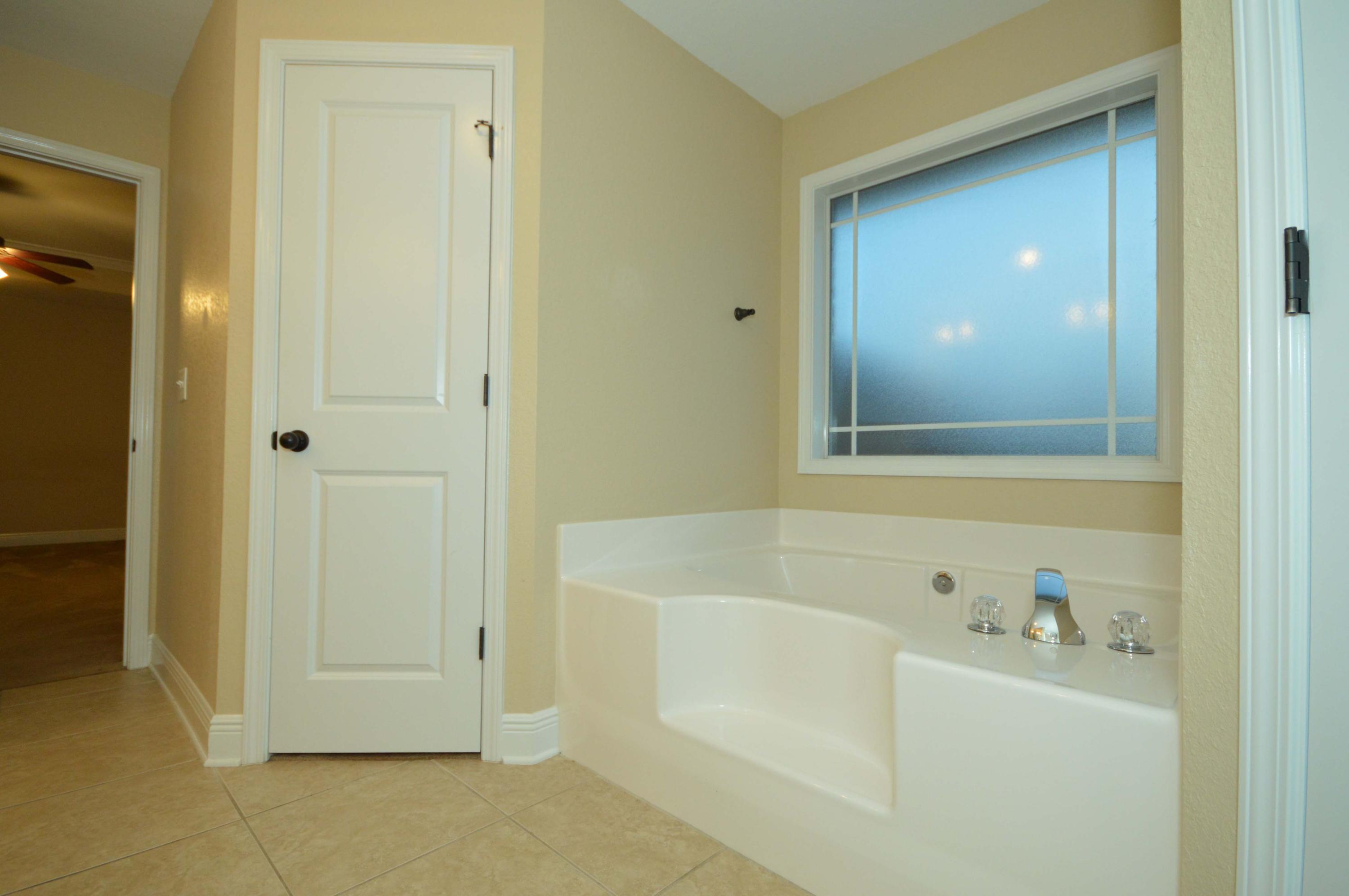 9970 Nichols Lake Road Milton, FL 32583 - Photo 36 of 48 a bathroom with a bathtub
