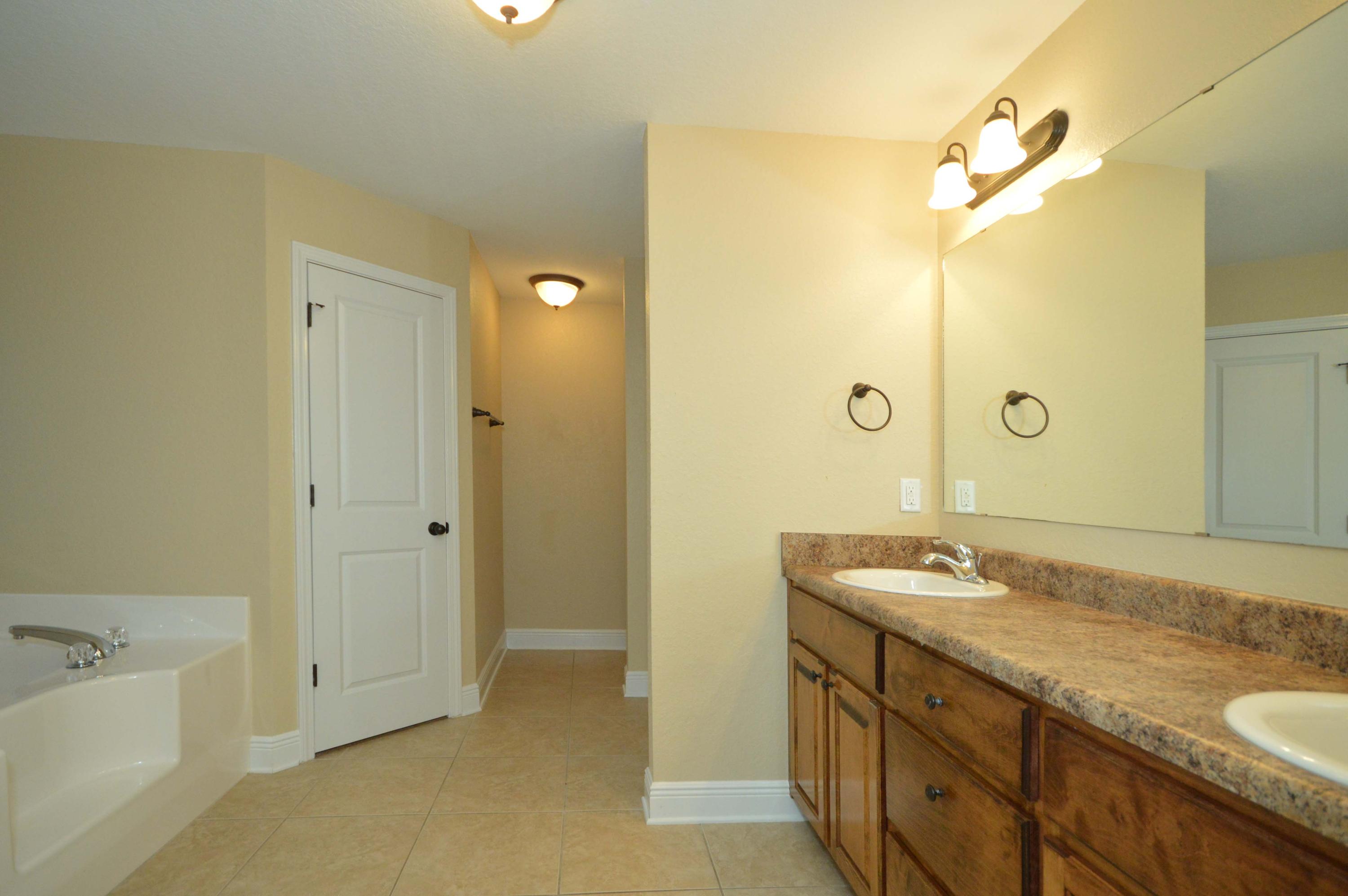 9970 Nichols Lake Road Milton, FL 32583 - Photo 37 of 48 a bathroom with a granite countertop sink mirror and double