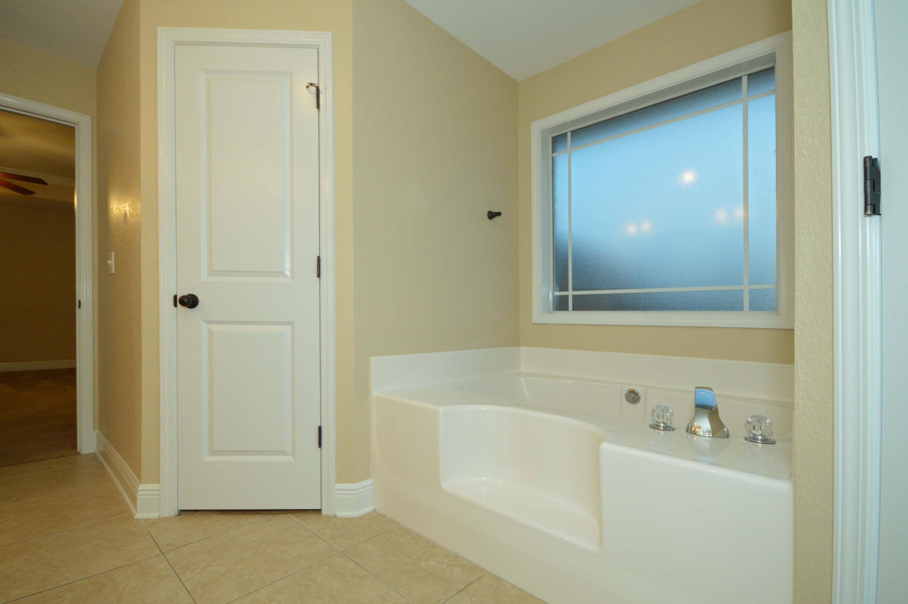 9970 Nichols Lake Road Milton, FL 32583 - Photo 38 of 48 a bathroom with a bathtub