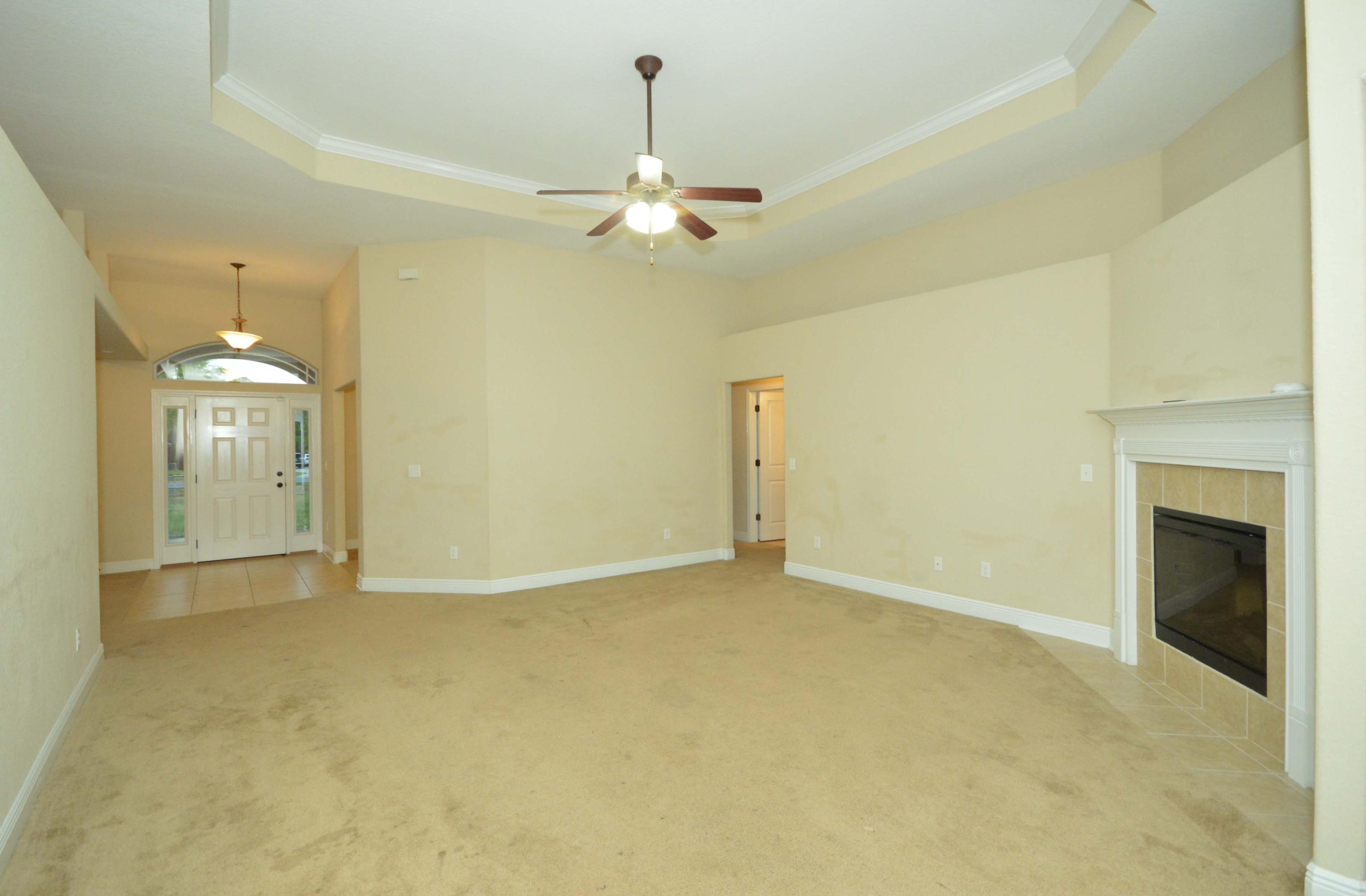 9970 Nichols Lake Road Milton, FL 32583 - Photo 8 of 48 a view of an empty room with a fireplace