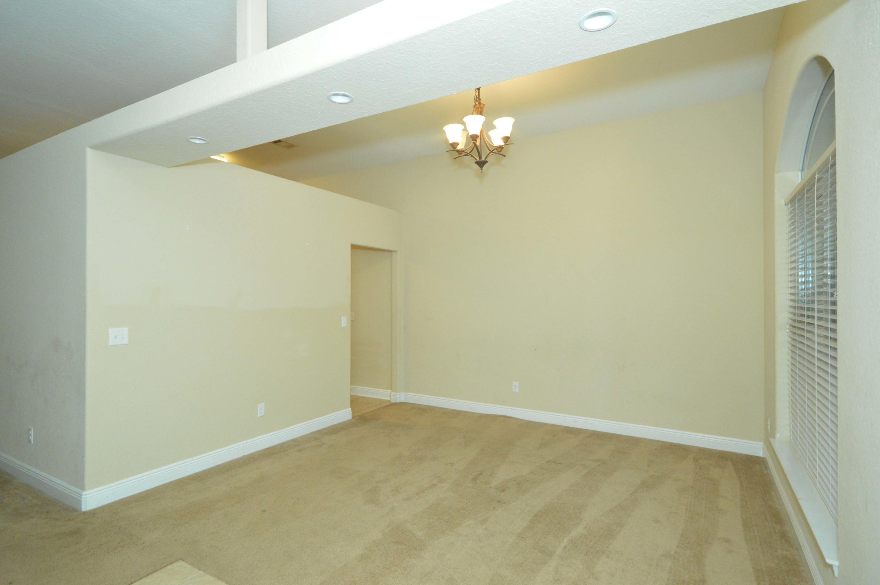 9970 Nichols Lake Road Milton, FL 32583 - Photo 9 of 48 an empty room with a chandelier fan