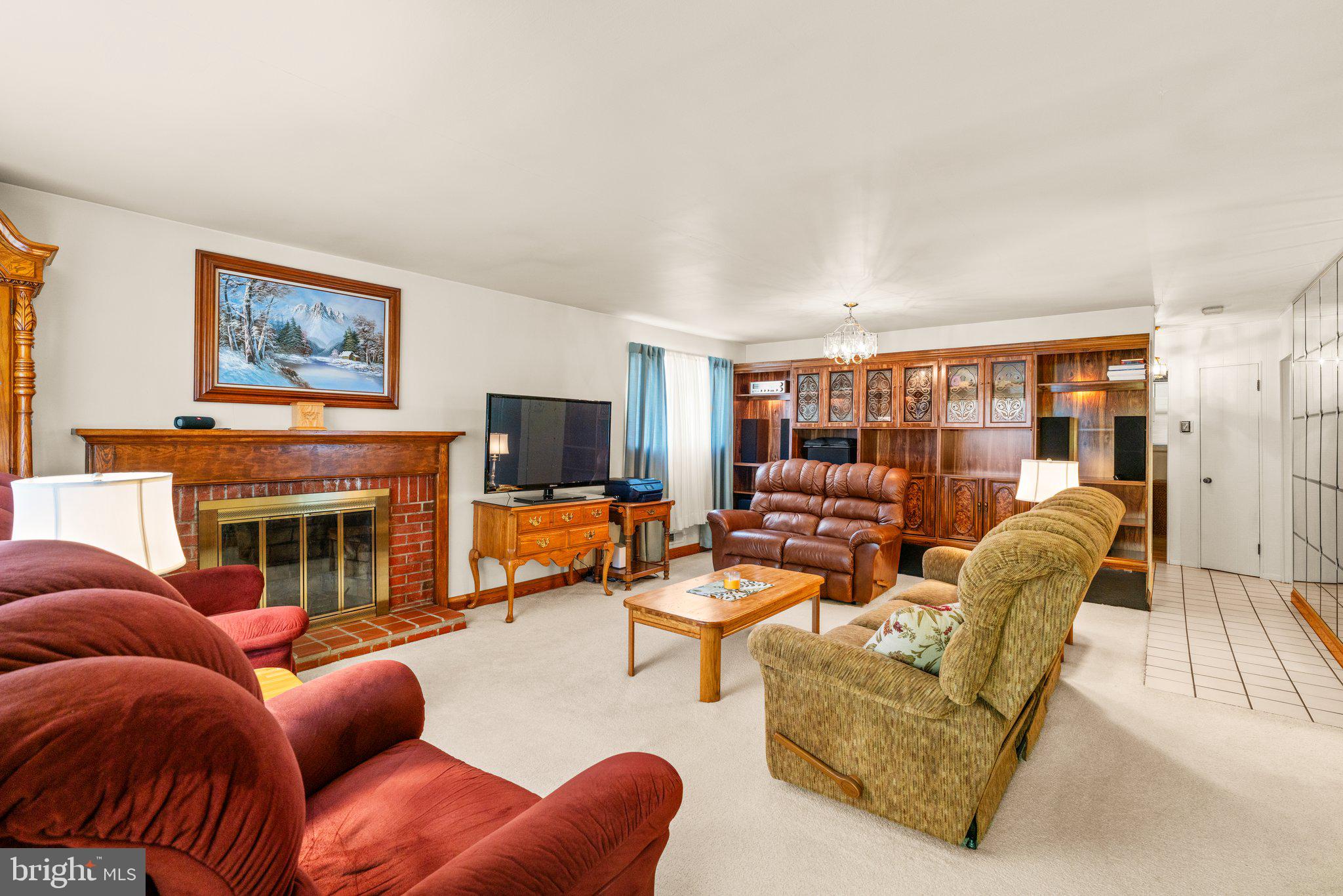 1814 Tyler Road Dundalk, MD 21222 - Photo 2 of 30 a living room with furniture a fireplace and a flat screen tv