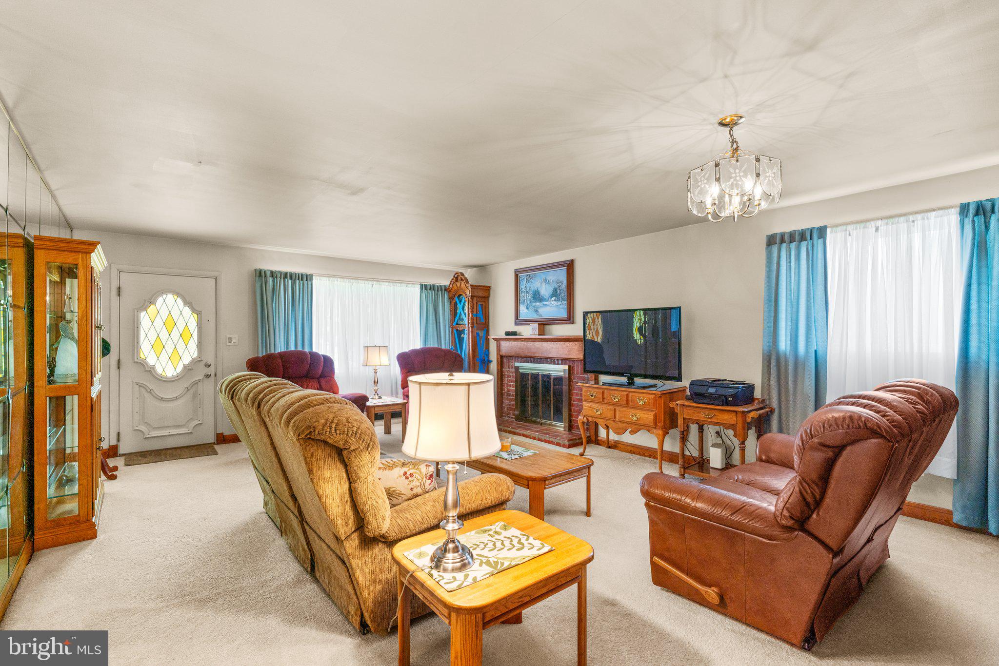 1814 Tyler Road Dundalk, MD 21222 - Photo 3 of 30 a living room with furniture a chandelier and a flat screen tv
