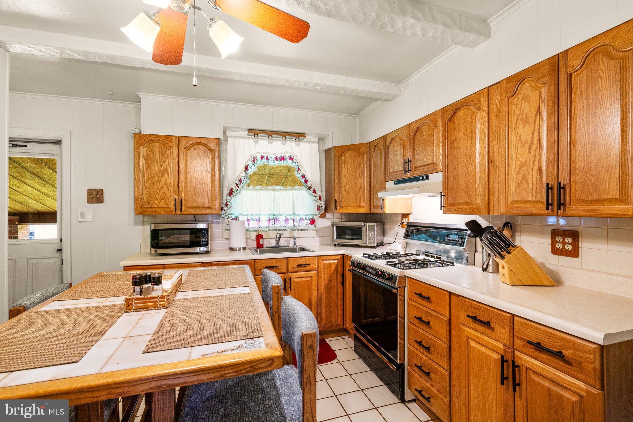 1814 Tyler Road Dundalk, MD 21222 - Photo 6 of 30 a kitchen with stainless steel appliances a sink stove and cabinets