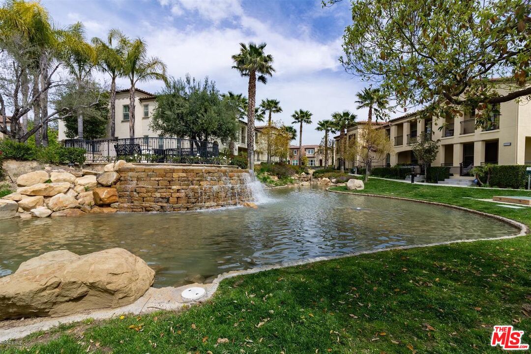 20427 Paseo Azul Porter Ranch, CA 91326 - Photo 11 of 38 a view of a lake with a building in the background
