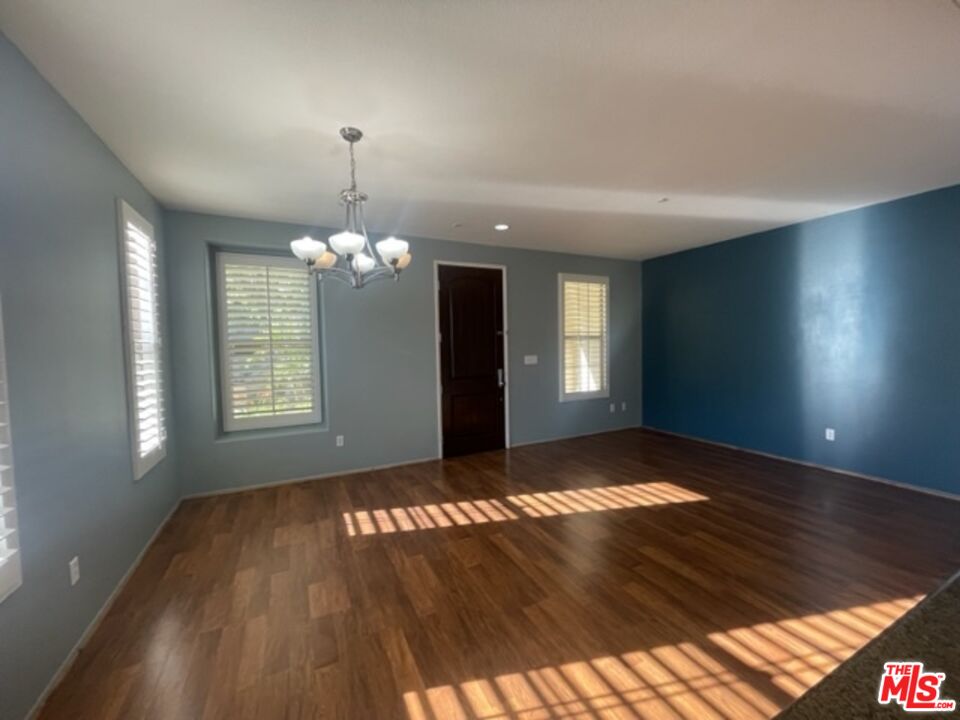 20427 Paseo Azul Porter Ranch, CA 91326 - Photo 19 of 38 a view of an empty room with wooden floor and a window