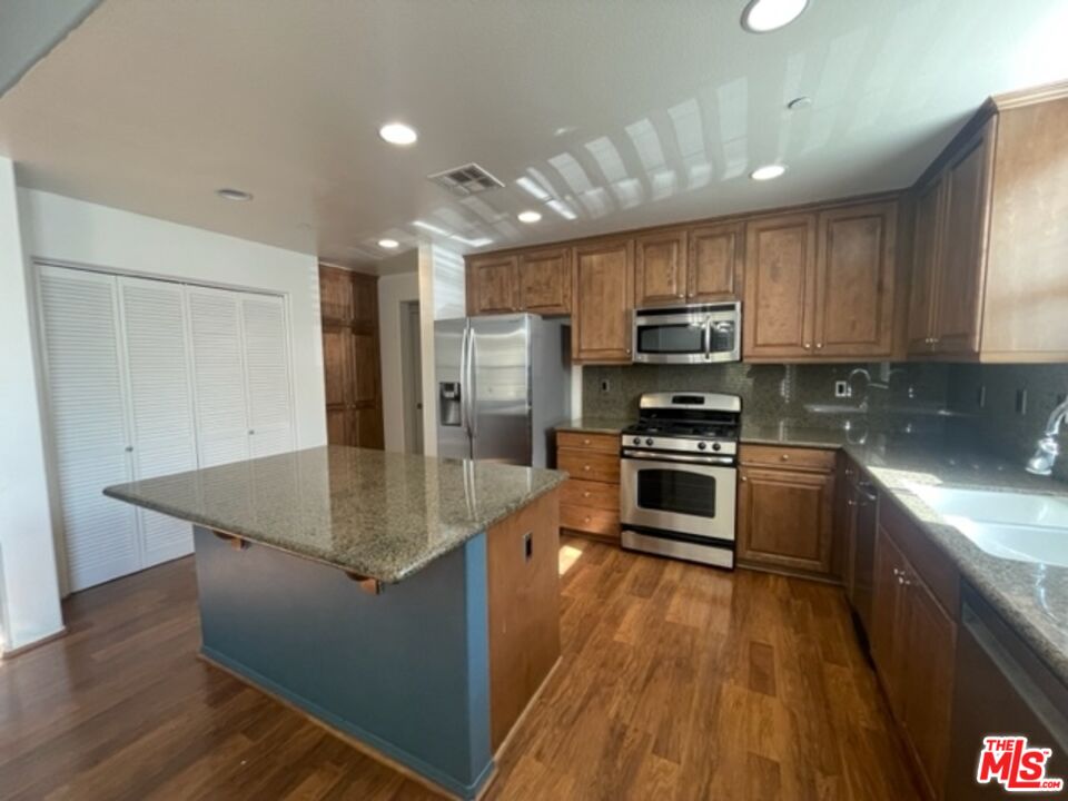 20427 Paseo Azul Porter Ranch, CA 91326 - Photo 22 of 38 a kitchen with stainless steel appliances granite countertop a stove a sink and a refrigerator