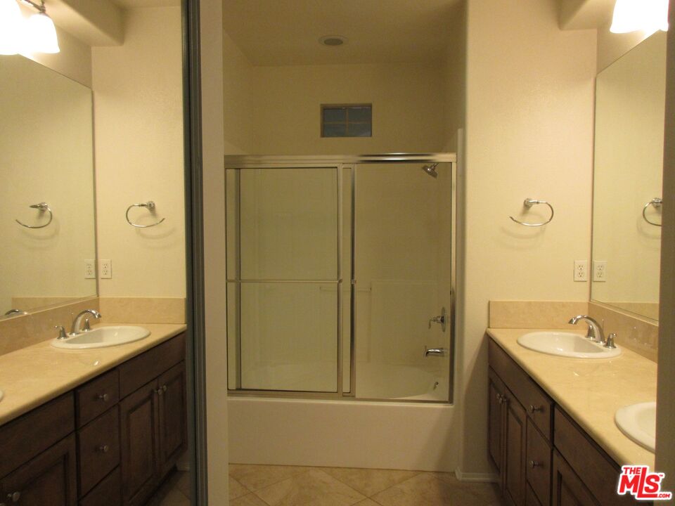 20427 Paseo Azul Porter Ranch, CA 91326 - Photo 31 of 38 a bathroom with a granite countertop sink shower and a mirror