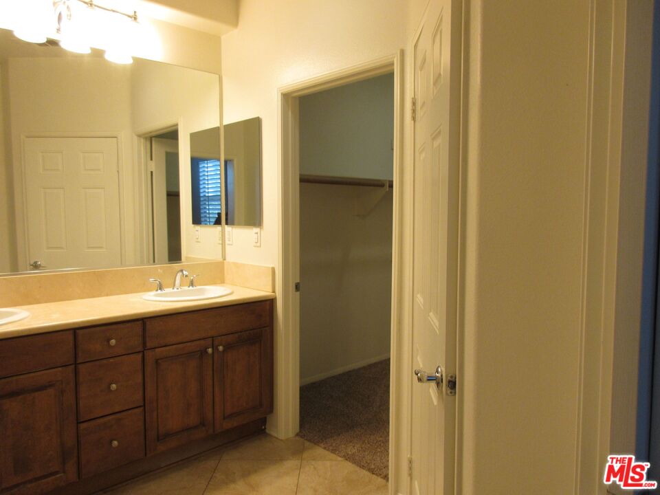 20427 Paseo Azul Porter Ranch, CA 91326 - Photo 35 of 38 a bathroom with a double vanity sink and mirror