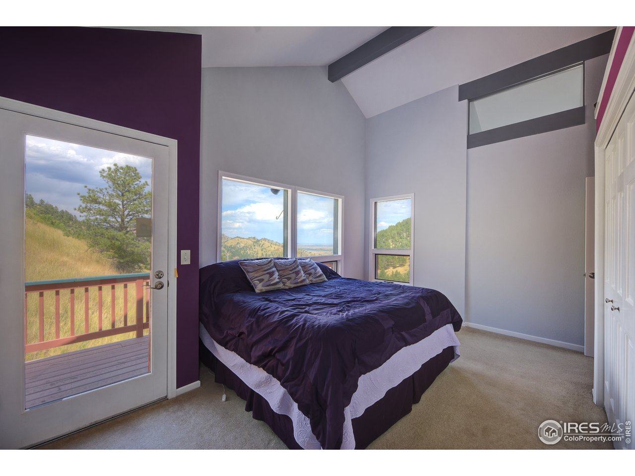 635 North Cedar Brook Road Boulder, CO 80304 - Photo 17 of 39 a bed sitting in a bedroom next to a window