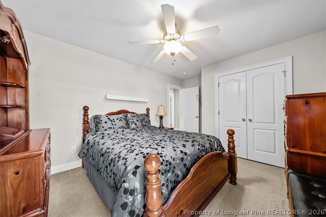 2708 Plum Ridge Road Fayetteville, NC 28306 - Photo 18 of 27 a bedroom with a bed and a chandelier