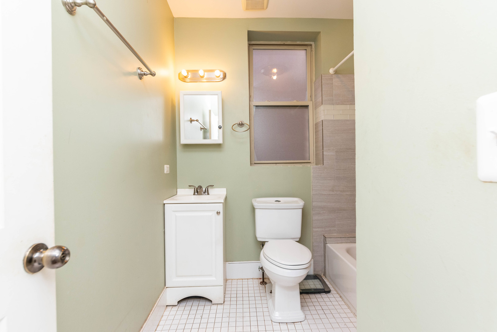 2812 East 76th Street, Unit 3 Chicago, IL 60649 - Photo 12 of 21 a bathroom with a toilet and a mirror