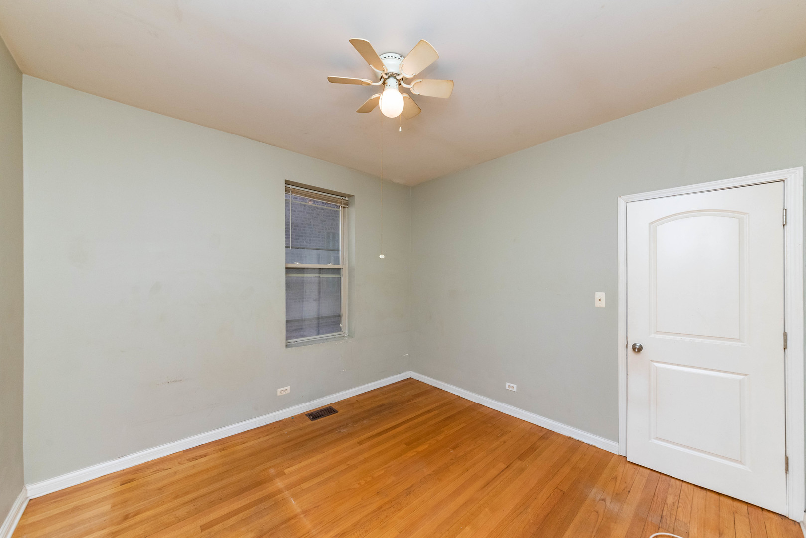 2812 East 76th Street, Unit 3 Chicago, IL 60649 - Photo 14 of 21 wooden floor in an empty room with a window