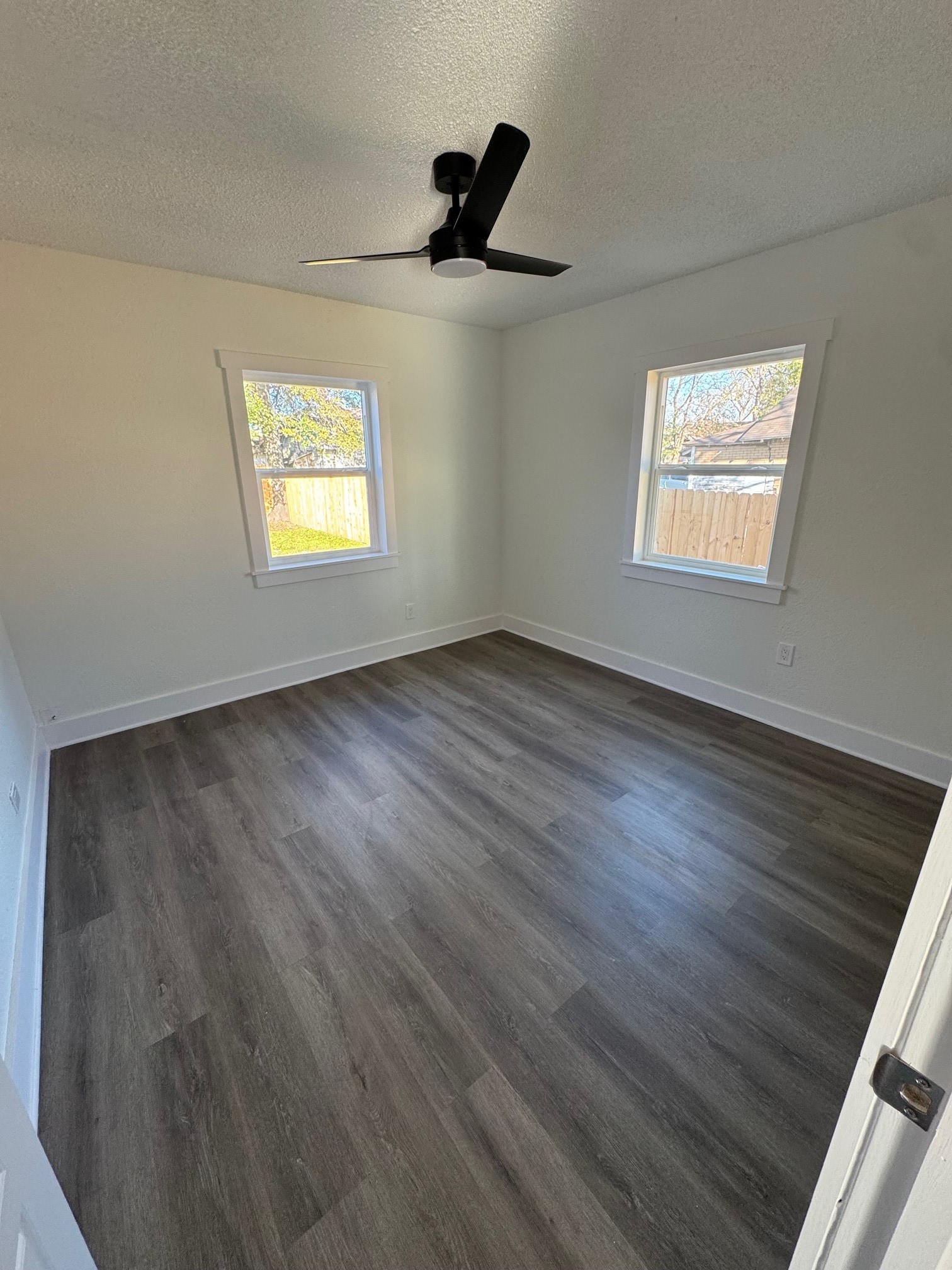 7909 Goode Street, Unit A Houston, TX 77012 - Photo 11 of 25 wooden floor in an empty room with a window