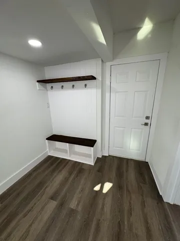 a view of a room with wooden floor