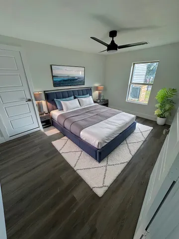 a bedroom with a bed and wooden floor