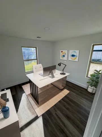 a living room with a couch and paintings on the wall