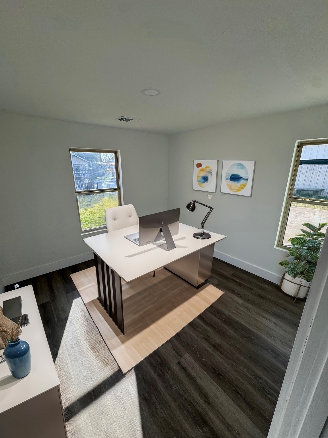 7909 Goode Street, Unit A Houston, TX 77012 - Photo 24 of 25 a living room with a couch and paintings on the wall