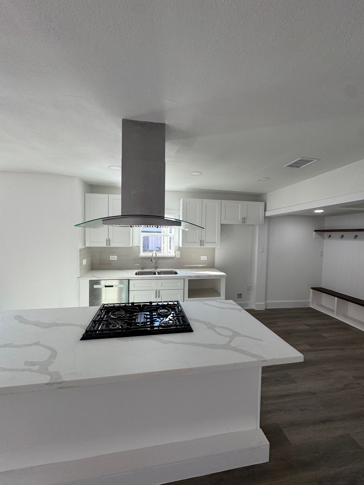 7909 Goode Street, Unit A Houston, TX 77012 - Photo 3 of 25 a kitchen with a stove and wooden floor