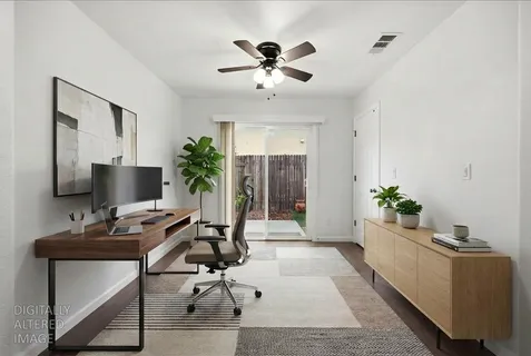 a workspace with furniture and a potted plant