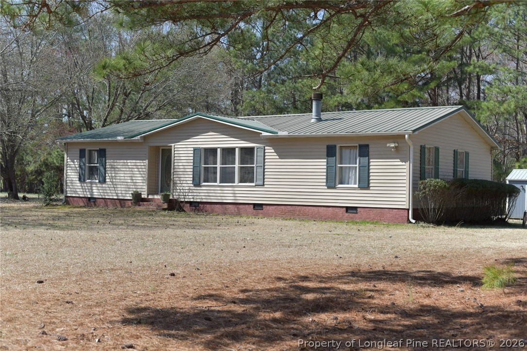 780 Old River Road Carthage, NC 28327 - Photo 1 of 28 a front view of a house with a garden