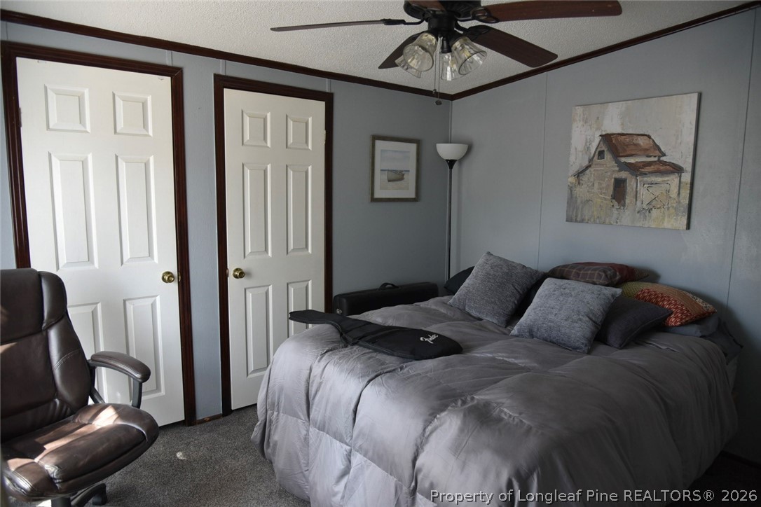 780 Old River Road Carthage, NC 28327 - Photo 16 of 28 a bedroom with a bed and wooden floor