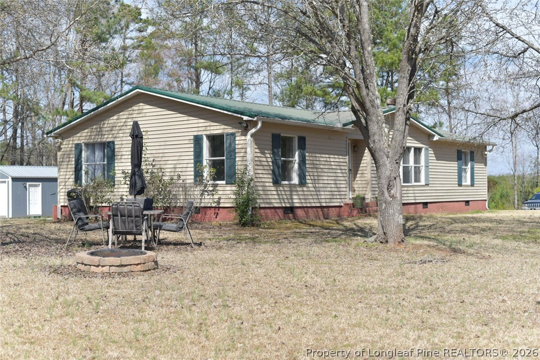 780 Old River Road Carthage, NC 28327 - Photo 2 of 28 a backyard of a house with table and chairs