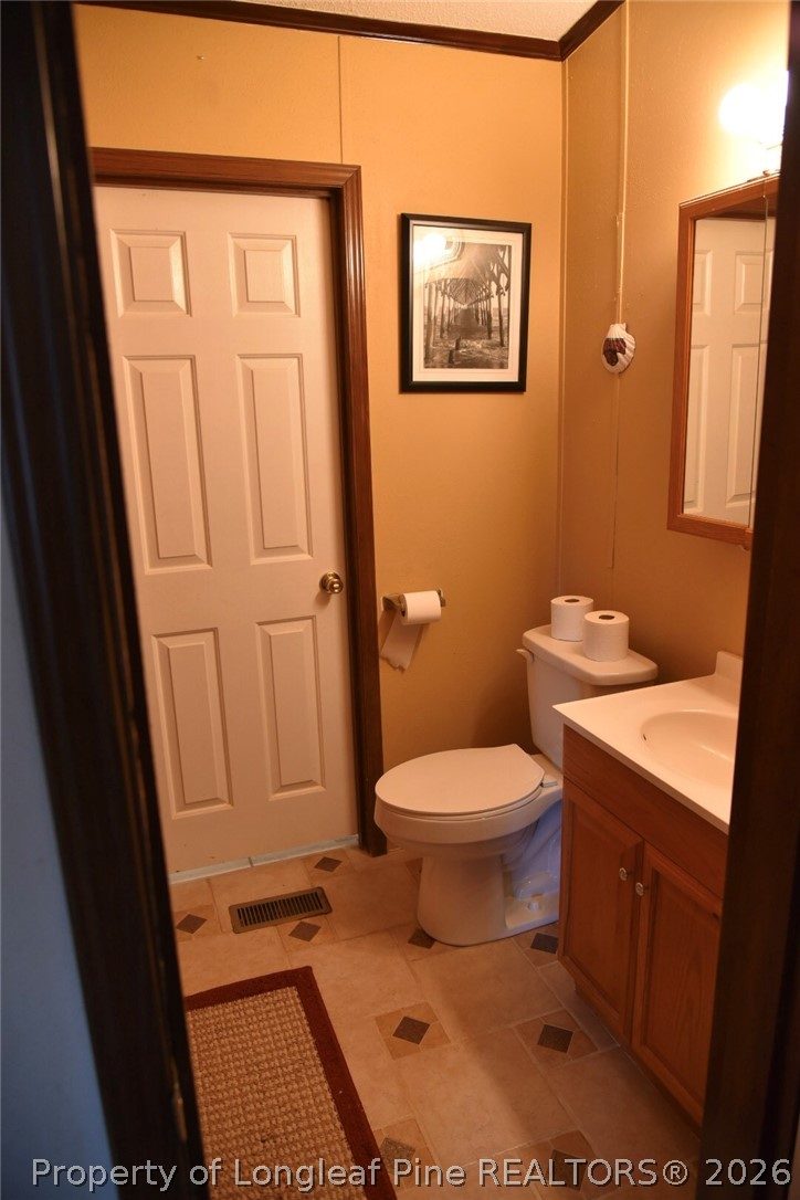 780 Old River Road Carthage, NC 28327 - Photo 22 of 28 a bathroom with a toilet and a sink