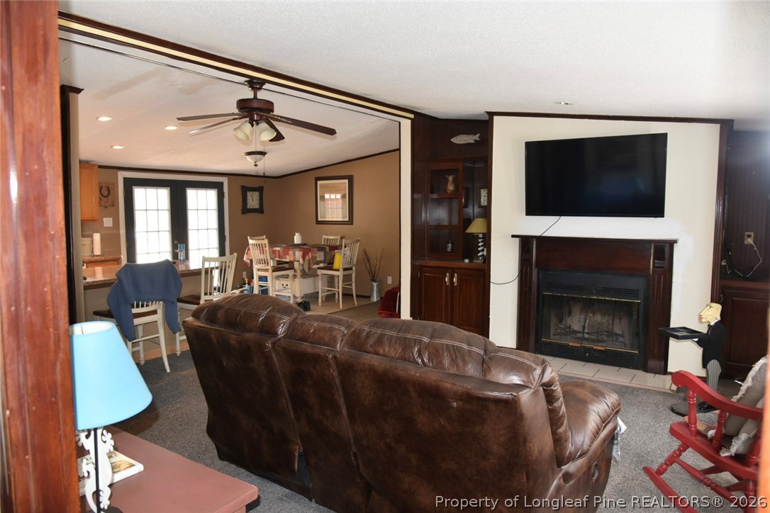 780 Old River Road Carthage, NC 28327 - Photo 4 of 28 a living room with furniture a flat screen tv and a fireplace
