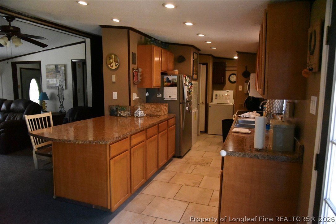 780 Old River Road Carthage, NC 28327 - Photo 7 of 28 a kitchen with stainless steel appliances kitchen island granite countertop a refrigerator and a stove