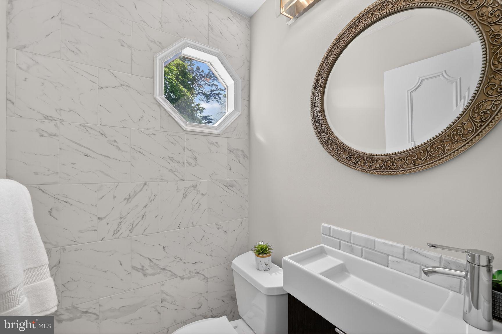 7265 Kousa Lane Springfield, VA 22152 - Photo 13 of 50 a bathroom with a sink and a mirror