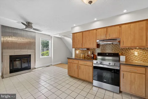 a kitchen with stainless steel appliances granite countertop a stove sink and cabinets