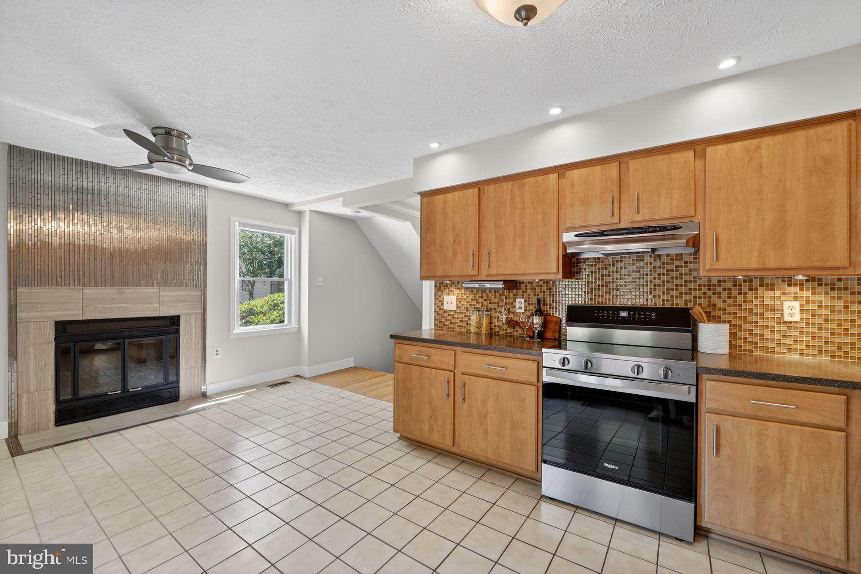 7265 Kousa Lane Springfield, VA 22152 - Photo 14 of 50 a kitchen with stainless steel appliances granite countertop a stove sink and cabinets