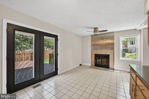 a view of an empty room with window and fire place
