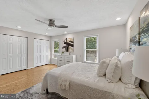 a bedroom with a large bed and a chandelier