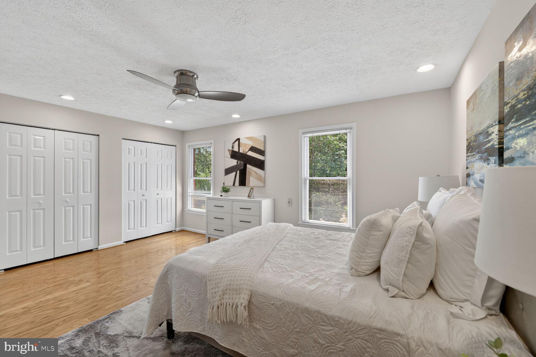 7265 Kousa Lane Springfield, VA 22152 - Photo 17 of 50 a bedroom with a large bed and a chandelier