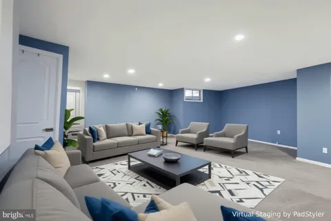 a living room with furniture and a rug