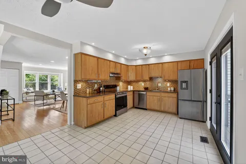 a kitchen with a sink appliances cabinets and furniture