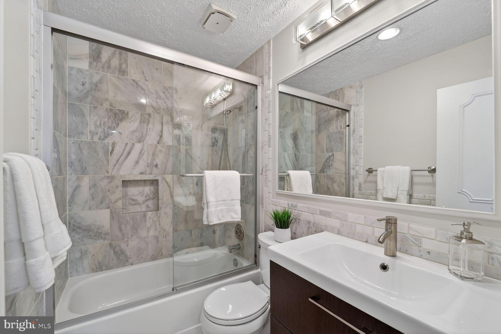 7265 Kousa Lane Springfield, VA 22152 - Photo 9 of 50 a bathroom with a sink toilet and shower