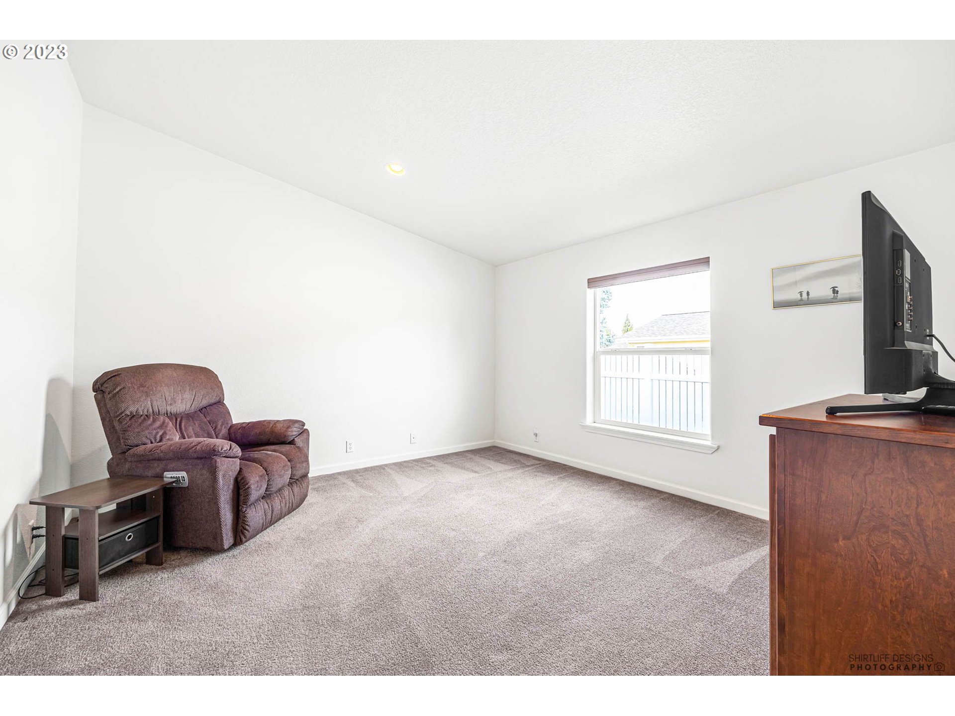2458 Blue Boy Lane Eugene, OR 97404 - Photo 21 of 28 a living room with furniture and a flat screen tv