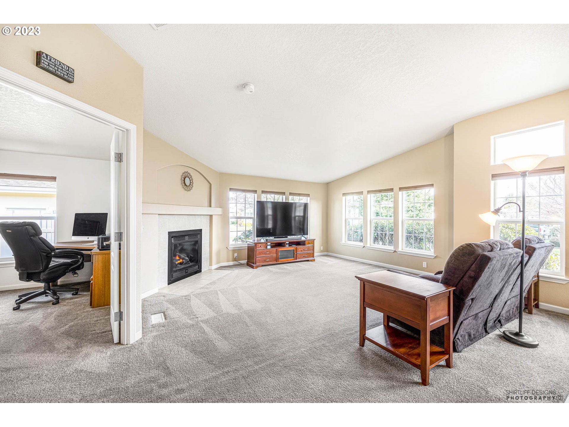 2458 Blue Boy Lane Eugene, OR 97404 - Photo 4 of 28 a living room with furniture a fireplace and a flat screen tv