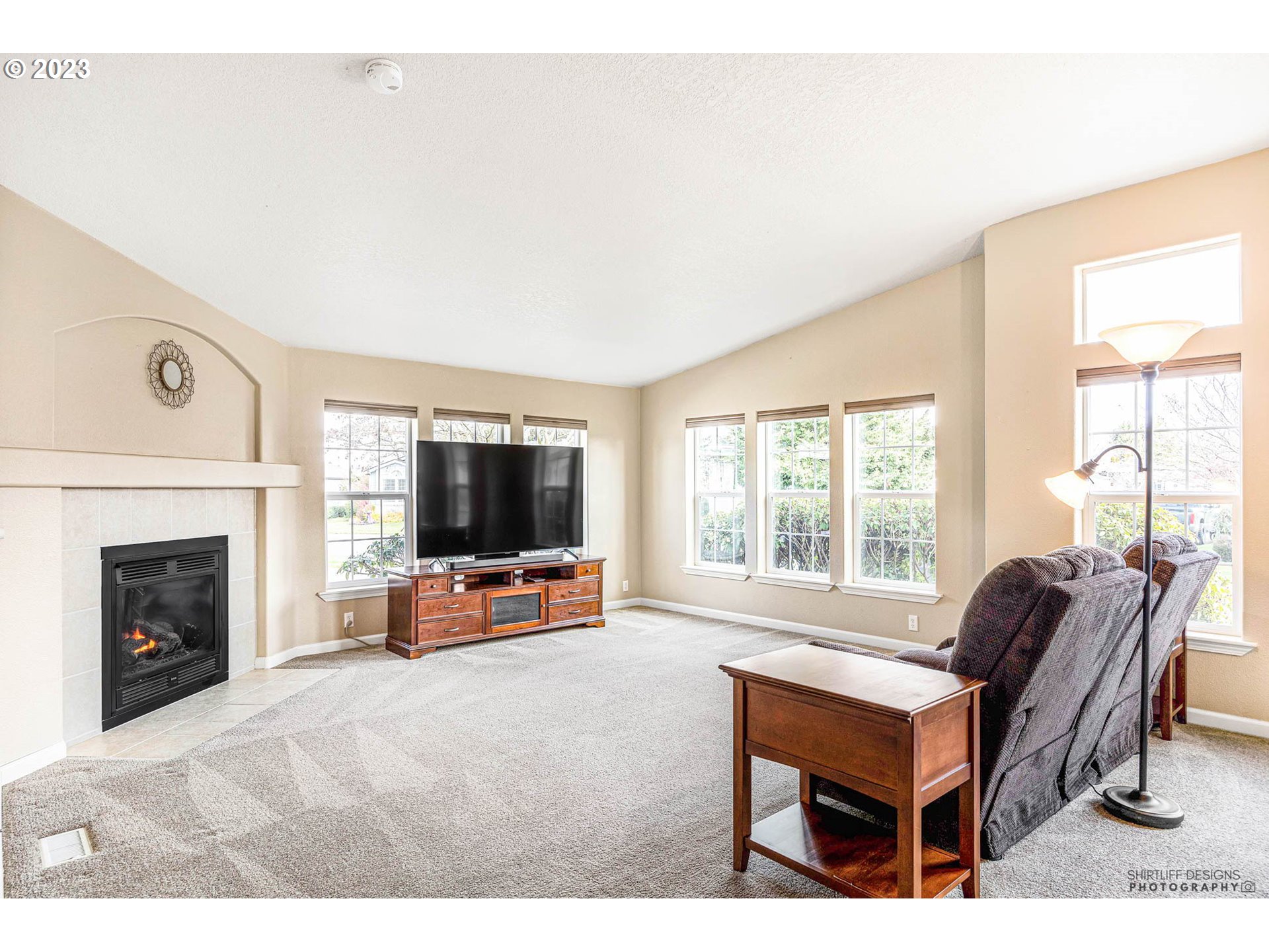 2458 Blue Boy Lane Eugene, OR 97404 - Photo 5 of 28 a living room with furniture a flat screen tv and a fireplace