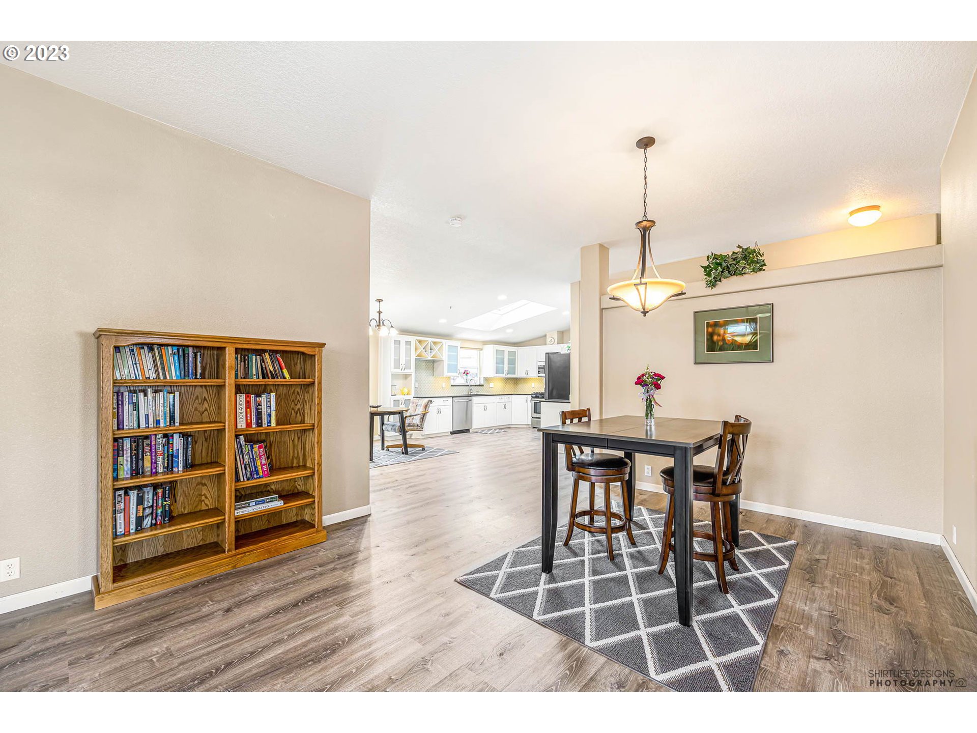 2458 Blue Boy Lane Eugene, OR 97404 - Photo 10 of 28 a dining room with furniture a book and wooden floor