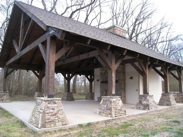 a view of a house with a big yard and large trees