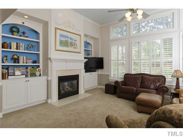 13136 Sargas Street Raleigh, NC 27614 - Photo 7 of 22 Large Family Room with built in bookshelves, plantation shutters and marble surround firplace. Perfect place to relax and unwind! Living Room