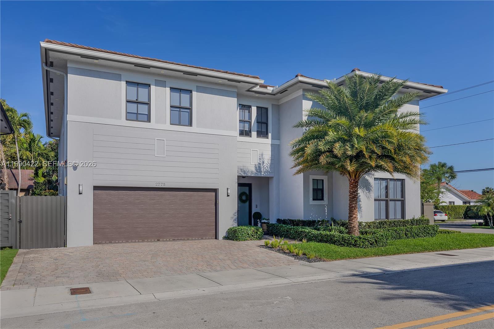 2775 Southwest 101st Court Miami, FL 33165 - Photo 43 of 46 a front view of a house with a yard and garage