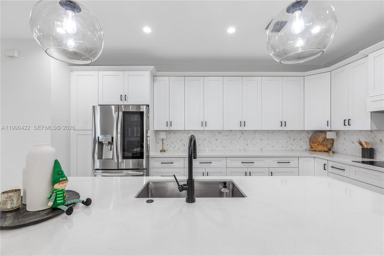 2775 Southwest 101st Court Miami, FL 33165 - Photo 9 of 46 a kitchen with stainless steel appliances a microwave a sink and cabinets